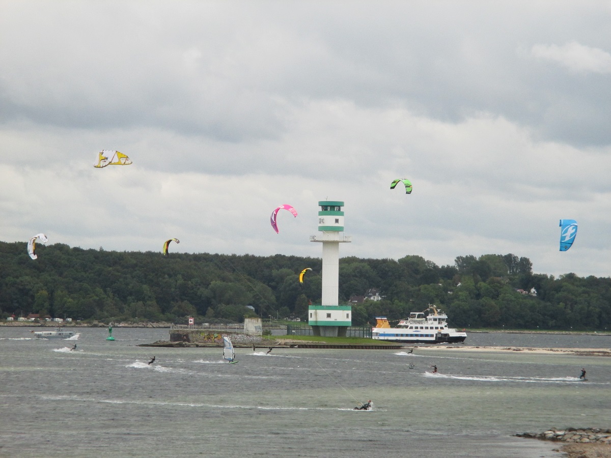 Kitesurfer am Friedrichsorter Leuchtturm und SFK Fähre in der Kieler Förde